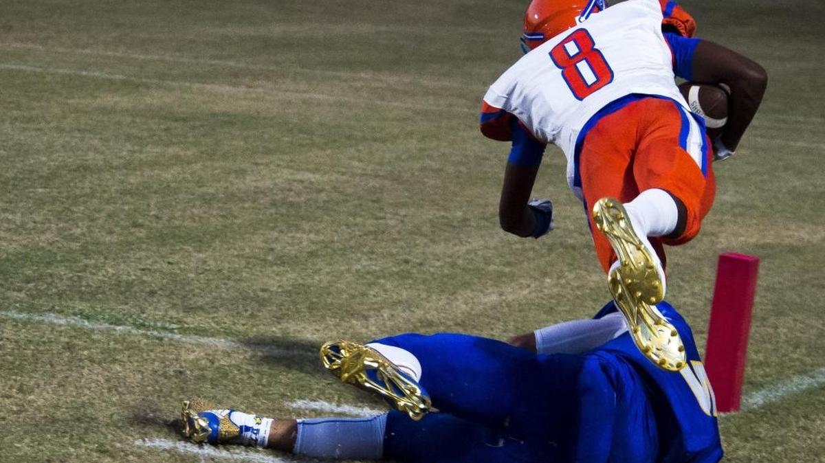 Southeast's Clyde Townsend leaps over Bayshores Miguel Rodriguez, narrowly missing a touchdown as Southeast faces off against Bayshore on Thursday evening at Bayshore High School in Bradenton.