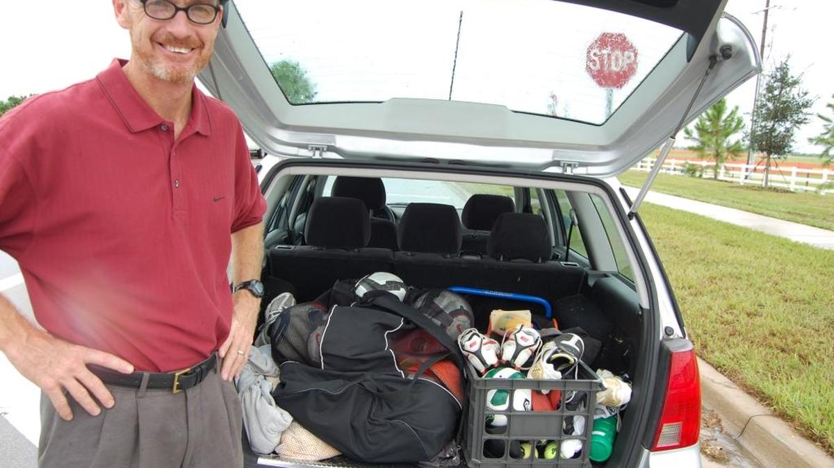 Tim Mulqeen poses behind his car filled with soccer equipment in 2011 at the Premier Sports Campus in Lakewood Ranch. Mulqueen was the director of sports at the facility.