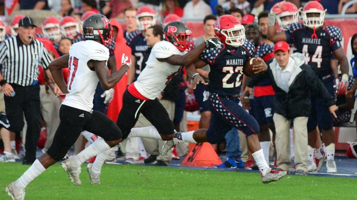 Manatee running back Joshua Booker picks up a first down on a fake punt against Palmetto in September. The schools remain district foes as the FHSAA released the final football districts for next season on Wednesday.