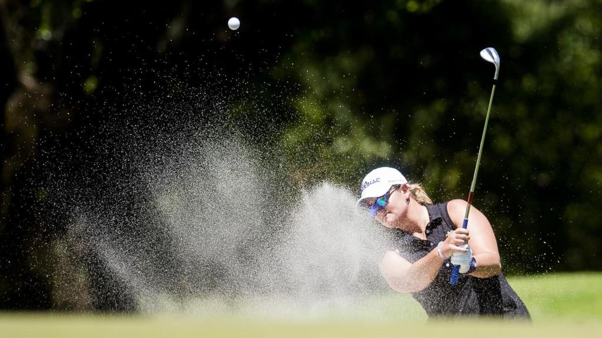 Erica Schneider of Bradenton chips her ball out of the sand trap while competing in the LPGA Symetra Tour first round on Friday afternoon at Sara Bay Country Club in Sarasota.