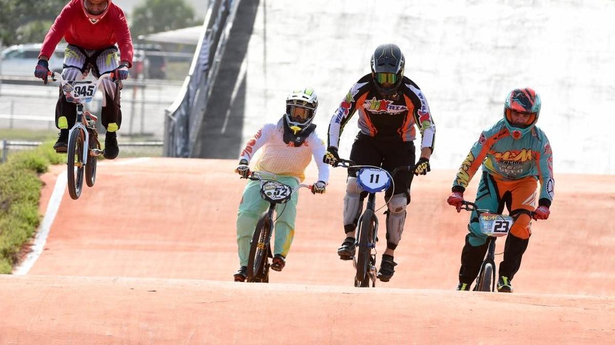 Pro riders get air off one of the moguls at the Sarasota BMX facility during the SSA Florida Cup Championship Saturday.