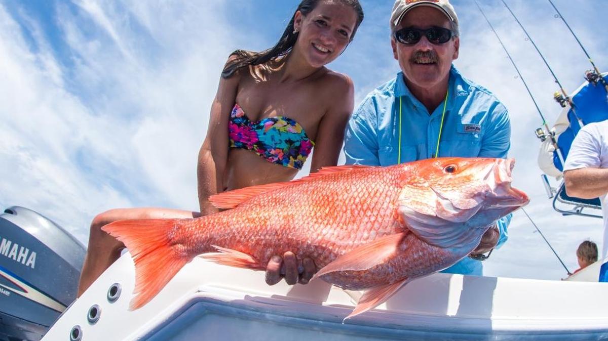 Victoria Chadsey and Taylor Chadsey Jr. hold an American red snapper caught in the Gulf of Mexico.