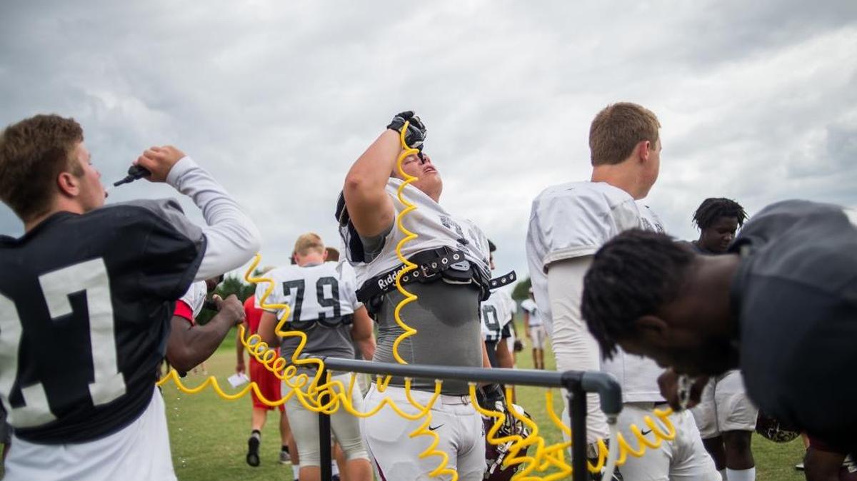 Braden River football players hydrate during a break in practice last October at Braden River High School.