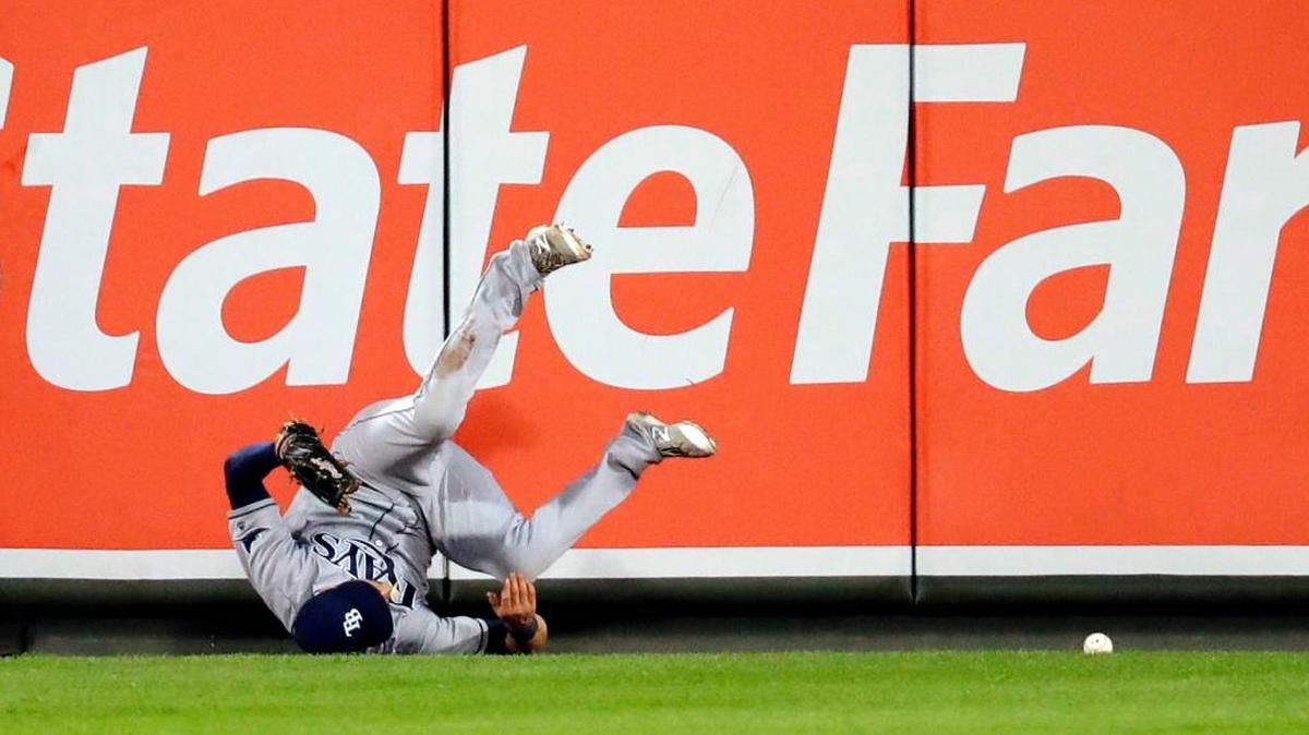 Tampa Bay center fielder Kevin Kiermaier collides with the outfield wall as he is unable to field a double by Baltimore’s J.J. Hardy during the first inning Thursday in Baltimore. Mark Trumbo and Matt Wieters scored on the play.