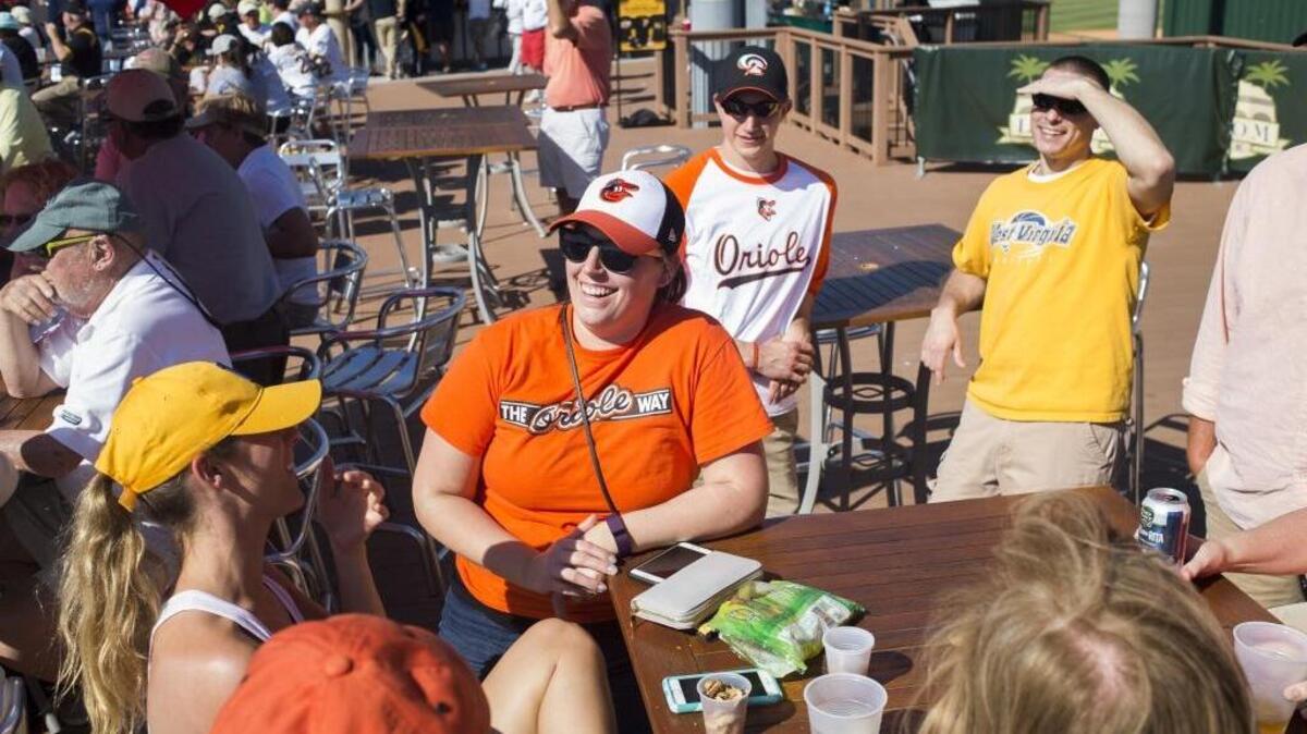 Pirates fans and Orioles fans chat together on the boardwalk behind right field during the Pittsburgh Pirate's spring training game against the Baltimore Orioles on Friday afternoon, March 3, 2017 at LECOM Park in Bradenton.