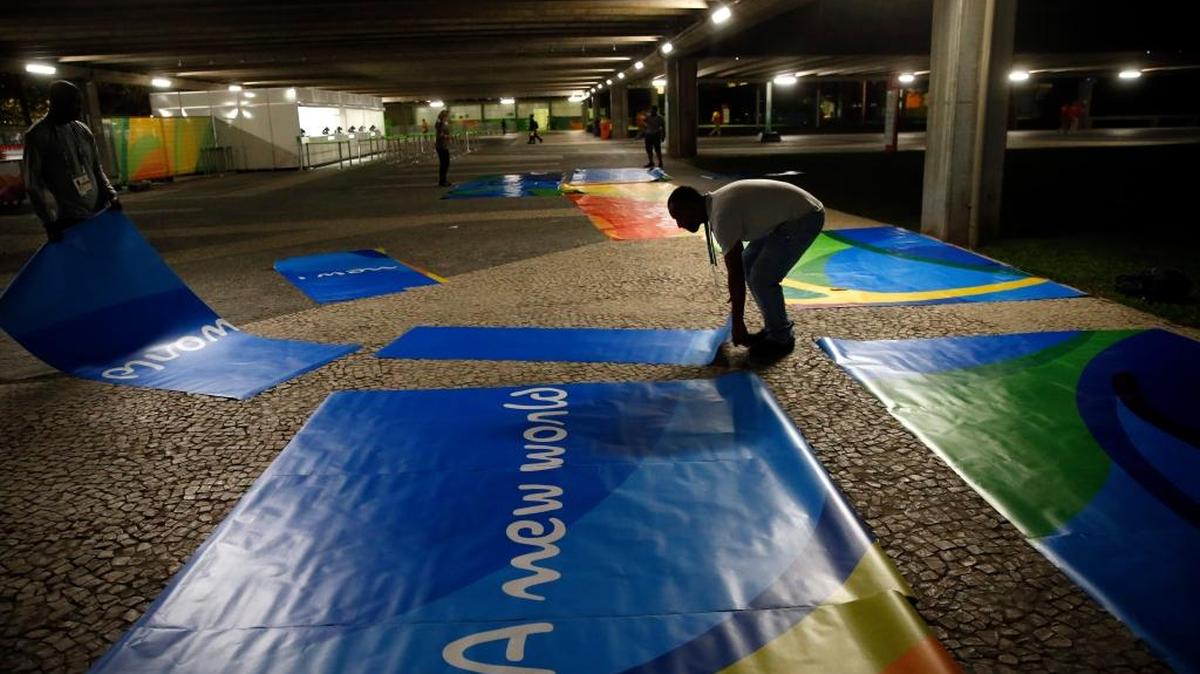 Workers put a signs together outside between pavilions at Riocentro as they prepare for the 2016 Summer Olympics in Rio de Janeiro, Brazil, Wednesday.
