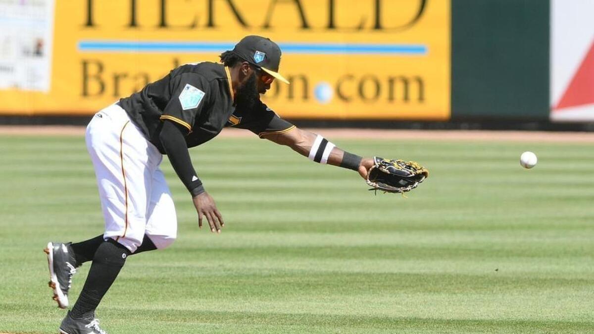 Pirates second baseman Josh Harrison can’t make the play during Monday’s game against the Red Sox at LECOM Park.