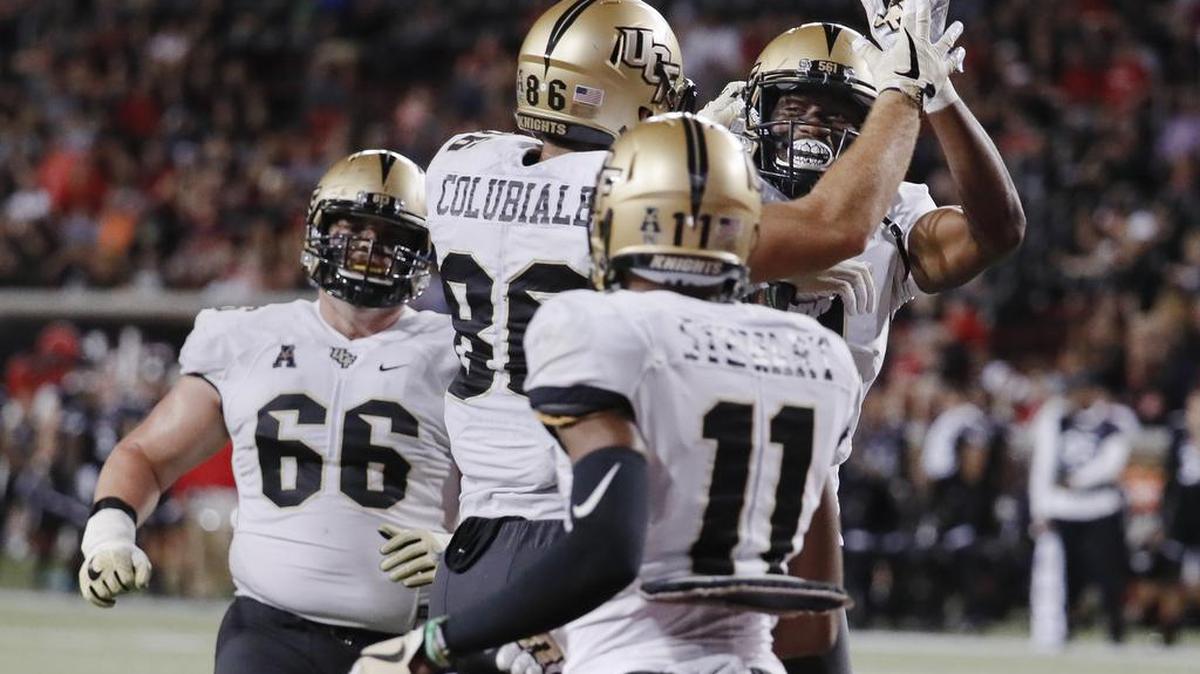 UCF tight end Michael Colubiale celebrates his touchdown with wide receiver Tre’Quan Smith, right, last Saturday against Cincinnati. The Knights have the highest-scoring offense in the nation.