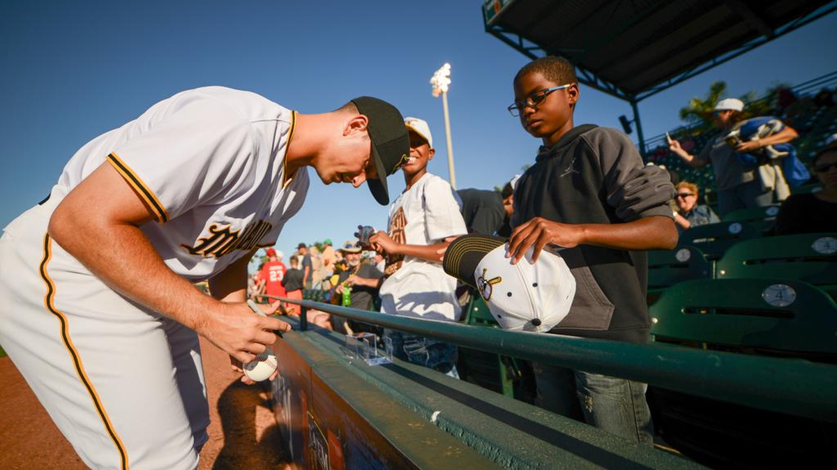 Jess Armedee (23) signs a baseball for Zy’iehere Baldwin from Bradenton during Saturday’s home opener in Bradenton. Armedee earned his second win of the season Wednesday in Port St. Lucie.