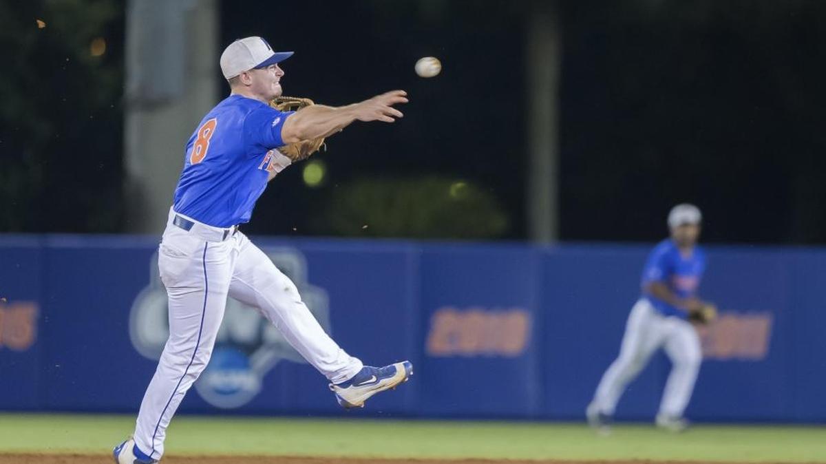 Florida’s Deacon Liput throws to first for an out to end Florida State’s scoring threat in the second inning in Game 3 of the NCAA college baseball tournament super regional in Gainesville on Monday.