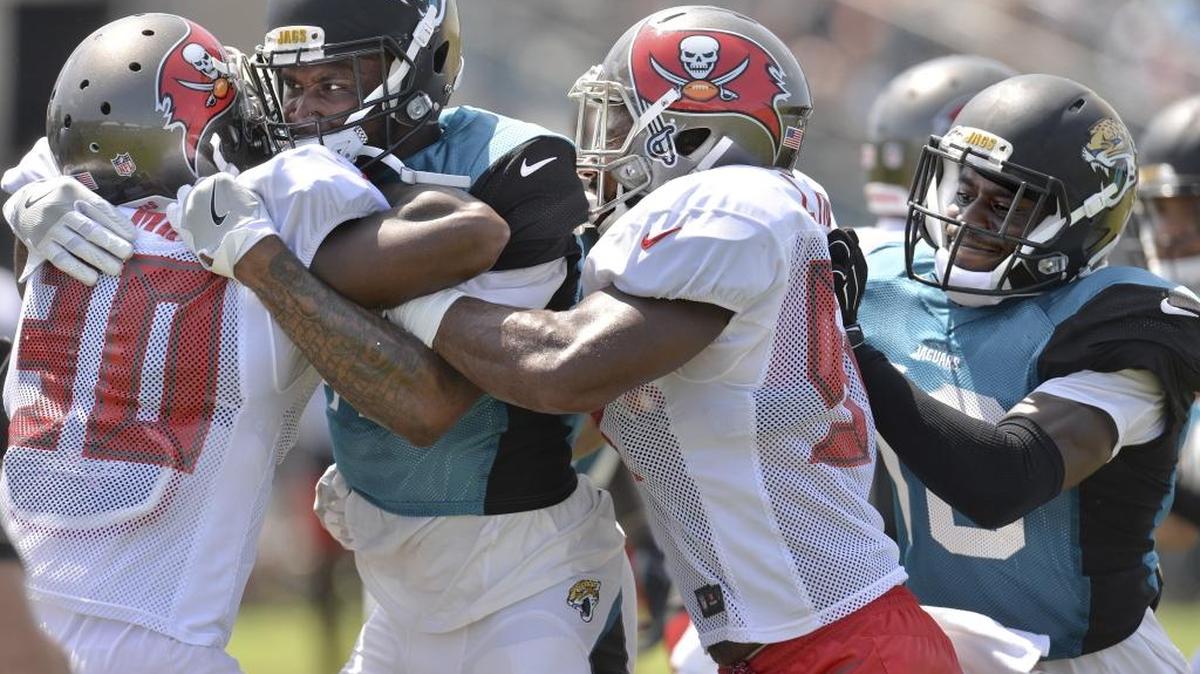 Tampa Bays Buccaneers Maurice Fleming (30) is grabbed by the Jacksonville Jaguars Jamal Robinson during a joint NFL football practice, Tuesday, Aug. 15, 2017 in Jacksonville, Fla.