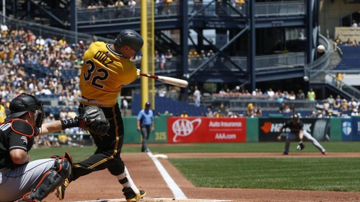 Pittsburgh Pirates' Elias Diaz (32) drives in two runs with a double off Miami Marlins starting pitcher Jeff Locke in the first inning of a baseball game in Pittsburgh, Sunday, June 11, 2017.