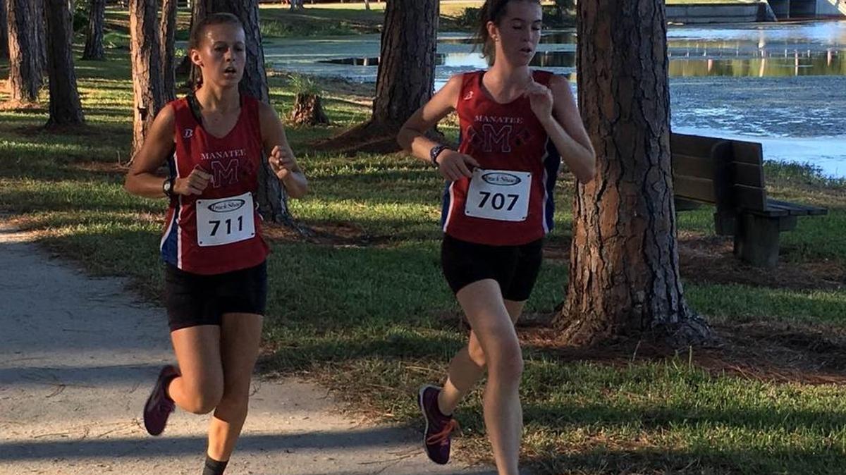 Alison Ecker, left, and Raquel Lespasio pace each other during the Class 4A-District 8 meet on Thursday at Taylor Park in Palm Harbor. The Manatee pair finished fourth and sixth in the girls race to qualify for the region race next week.