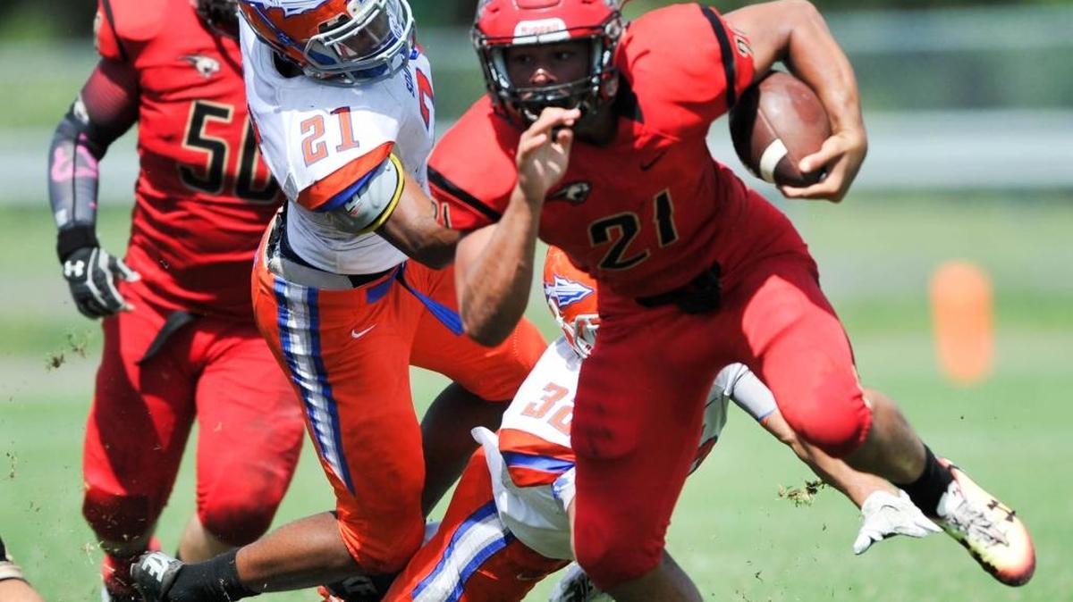 Cardinal Mooney’s Brice Williams eludes two Southeast defenders during a carry on Saturday during the Cougars’ homecoming victory.