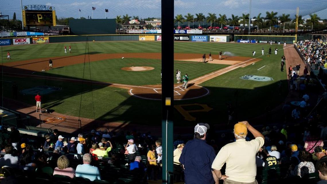 Fans take their seats as players warm up during the Pittsburgh Pirates spring training game against the Boston Red Sox on Tuesday evening at LECOM Park in Bradenton.