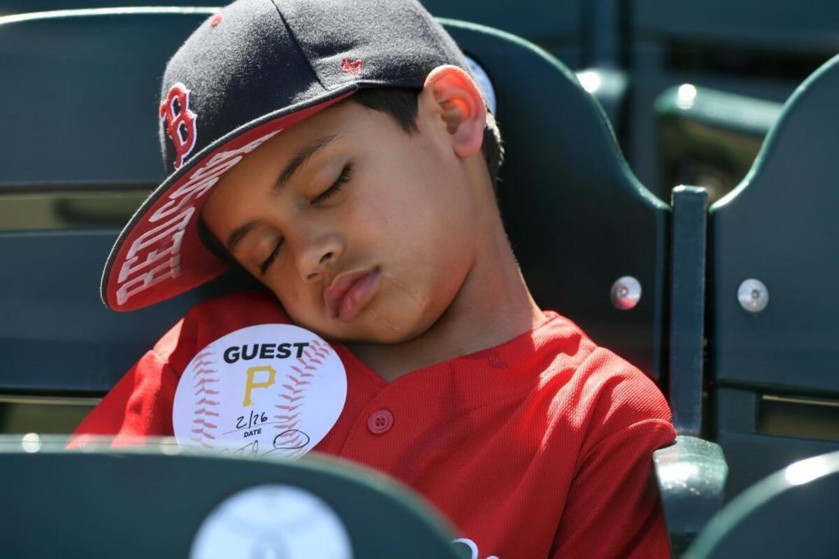 Logan Perez, 7, takes a quick nap before the Pirates hosted the Red Sox on Monday.