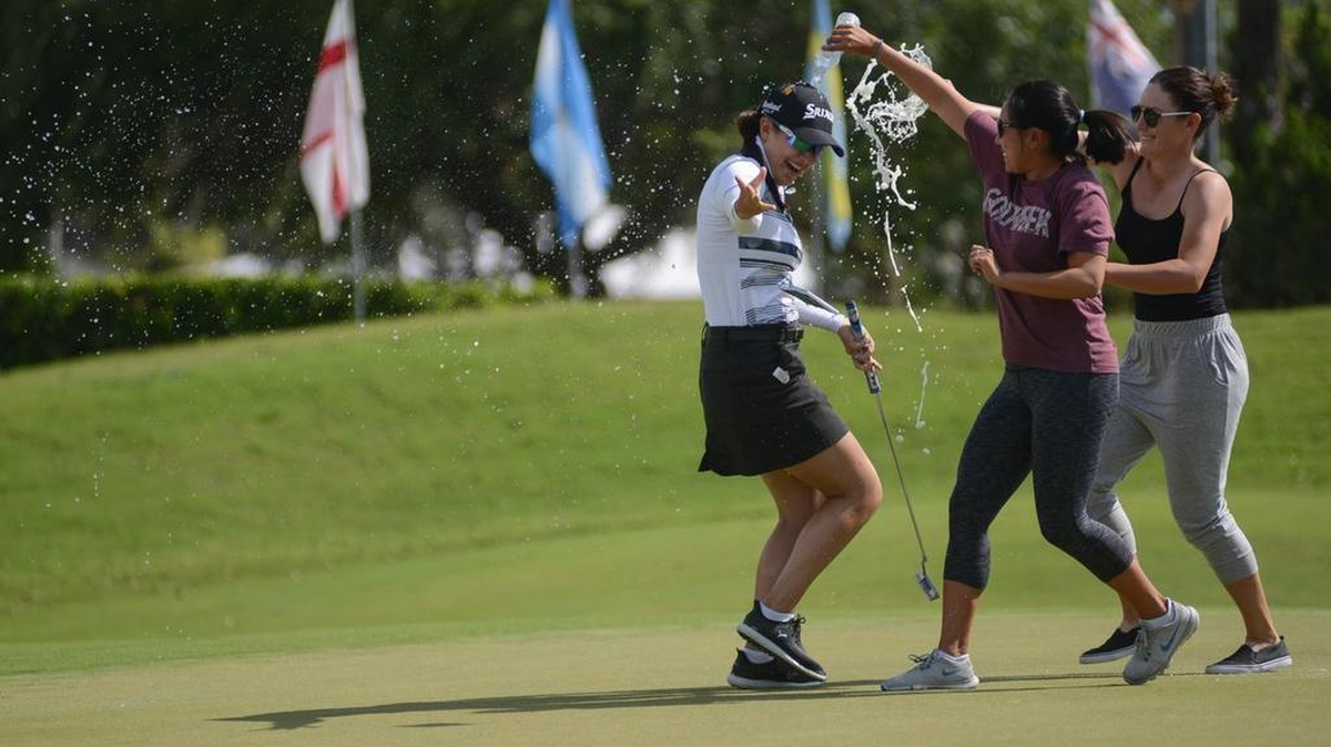 Hannah Green, left is doused by water and beer by a couple of friends on the 18th green after winning the Symetra Tour’s Sara Bay Classic at Sara Bay Country Club in Sarasota in April. Green finished 11th this past weekend on the Symetra Tour.