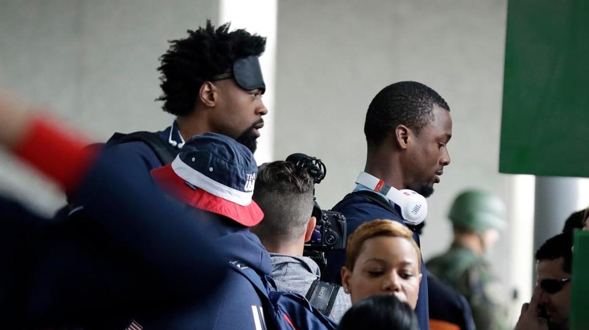 Unites States basketball players DeAndre Jordan, left, and Harrison Barnes board a bus at the airport after arriving at the 2016 Summer Olympics in Rio de Janeiro, Brazil, Aug. 3.