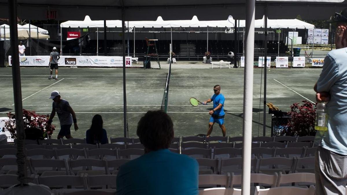 Spectators watch from the bleachers as players practice ahead of the Sarasota Open at United Tennis Academy on April 14.