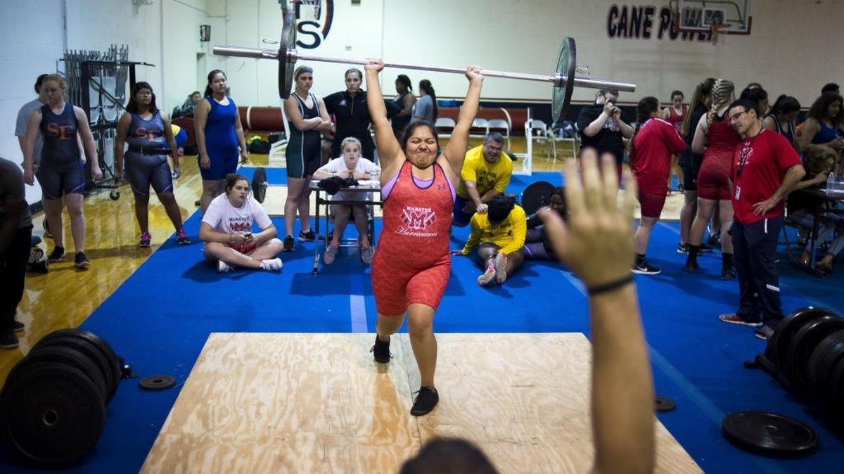 Manatee High School sophomore Esperanza Lopez pushes herself to the limit during the clean and jerk event at the Manatee County's Girls Weightlifting Championship on Tuesday afternoon, December 20, 2016 at Manatee High School in Bradenton.
