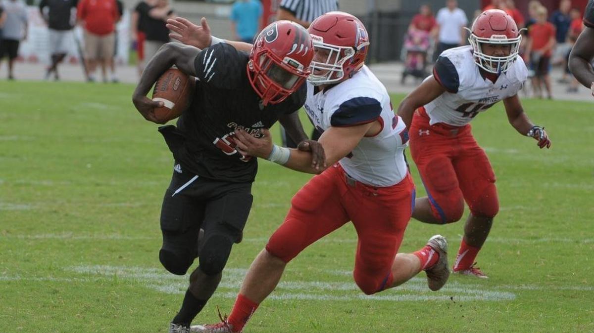 Palmetto High running back Eddravian Butler (35) tries to run through Manatee’s secondary. The Tigers play at Lake Gibson, while the Hurricanes play at Lutz Steinbrenner on Friday.