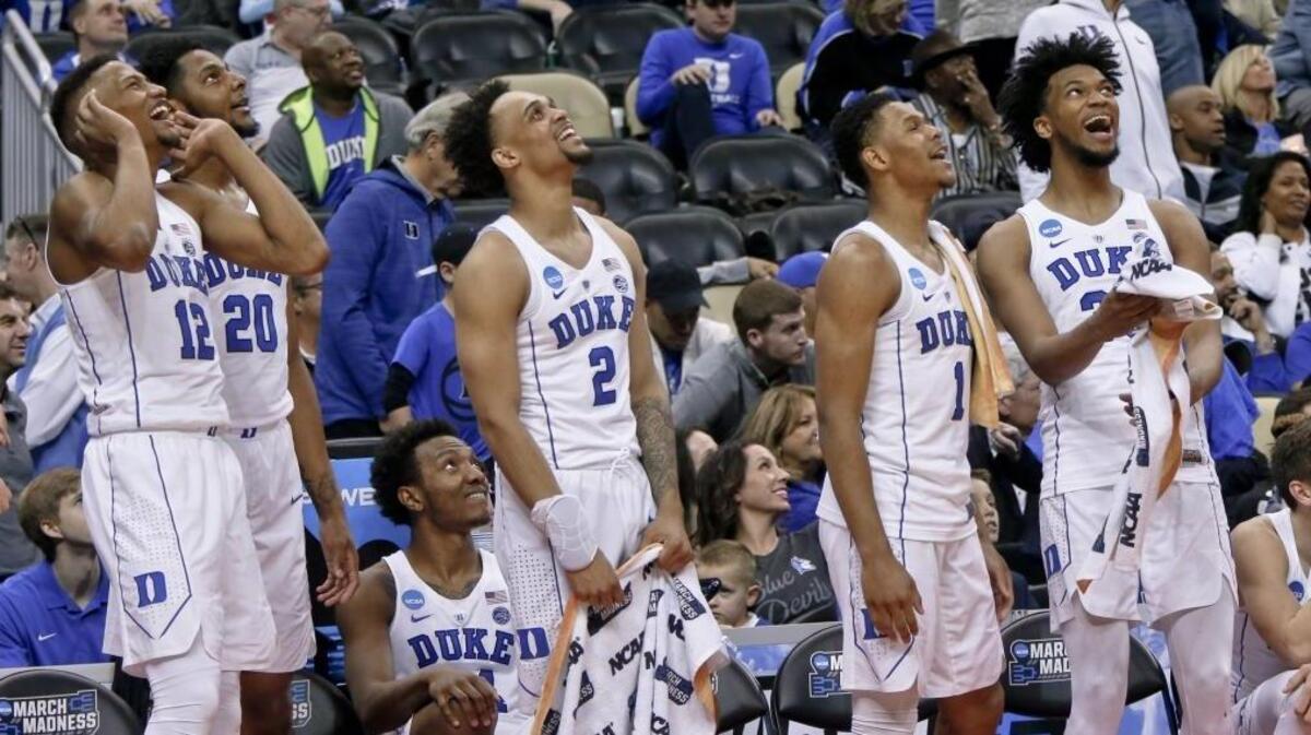 Duke’s Javin DeLaurier (12), Marques Bolden (20), Gary Trent Jr. (2), IMG Academy alumnus Trevon Duval (1) and Marvin Bagley III, right, cheer as they watch a replay of a dunk by teammate Justin Robinson during their first-round game March 15 against Iona in Pittsburgh.