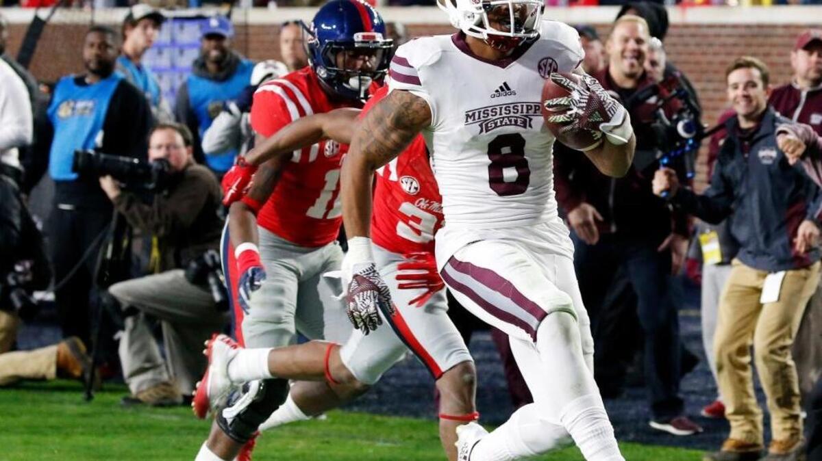 Mississippi State wide receiver Fred Ross (8) runs past a Mississippi defender for a 38-yard touchdown pass reception in Oxford, Miss., on Nov. 26.