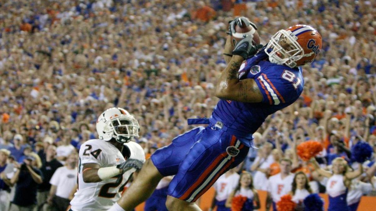 Florida tight end Aaron Hernandez pulls in a touchdown pass over Miami's Chavez Grant at Florida Field in 2008.