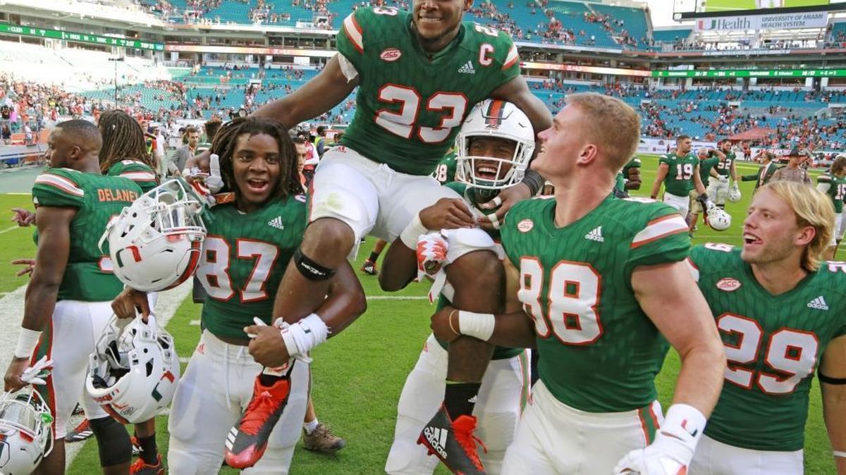 Miami Hurricanes senior tight end Christopher Herndon is carried off by teammates after Miami defeated the Virginia Cavaliers at Hard Rock Stadium on Saturday, November 18, 2017.