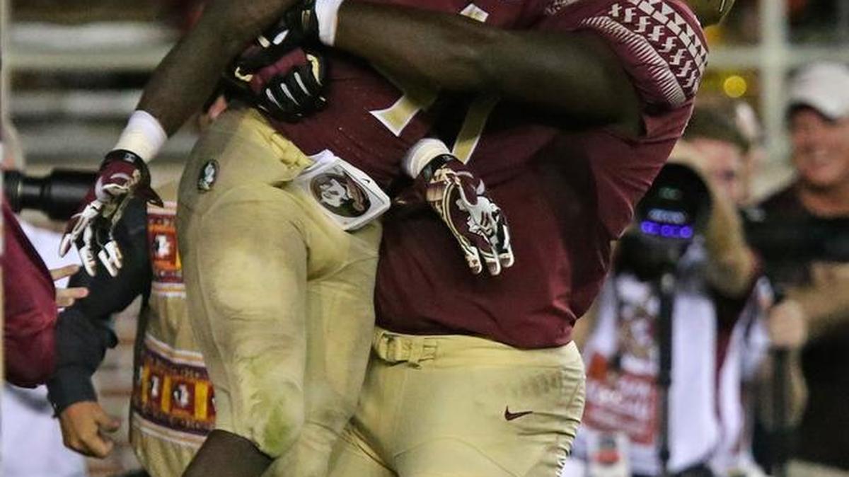 Roderick Johnson, shown picking up running back Dalvin Cook, and the rest of the offensive line has looked good during preseason practice.