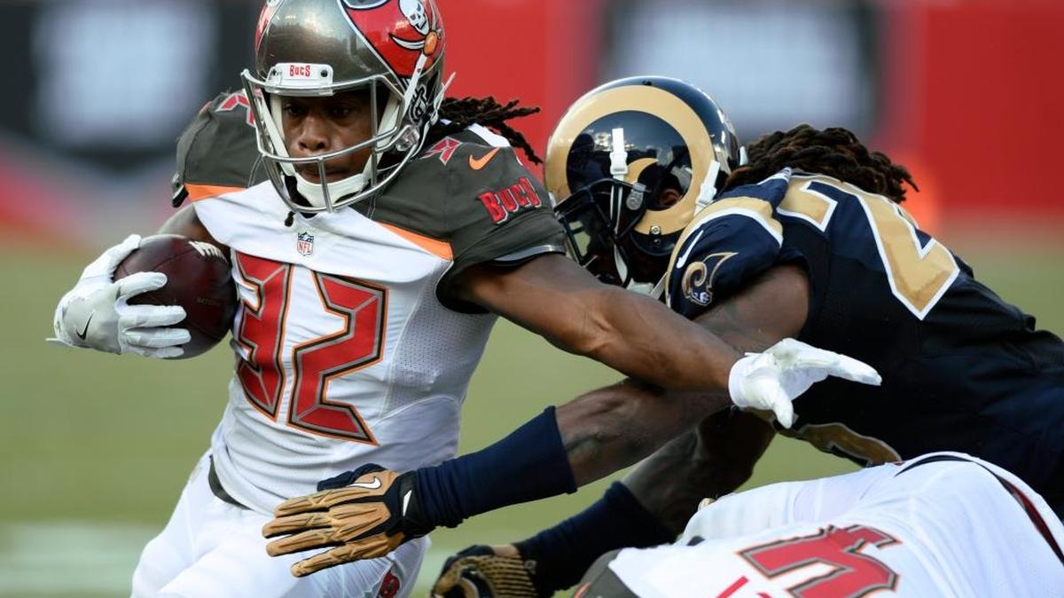 Tampa Bay running back Jacquizz Rodgers slips a tackle by Los Angeles linebacker Mark Barron during a game in Tampa last month. The Bucs head west to taken on the San Francisco 49ers on Sunday.