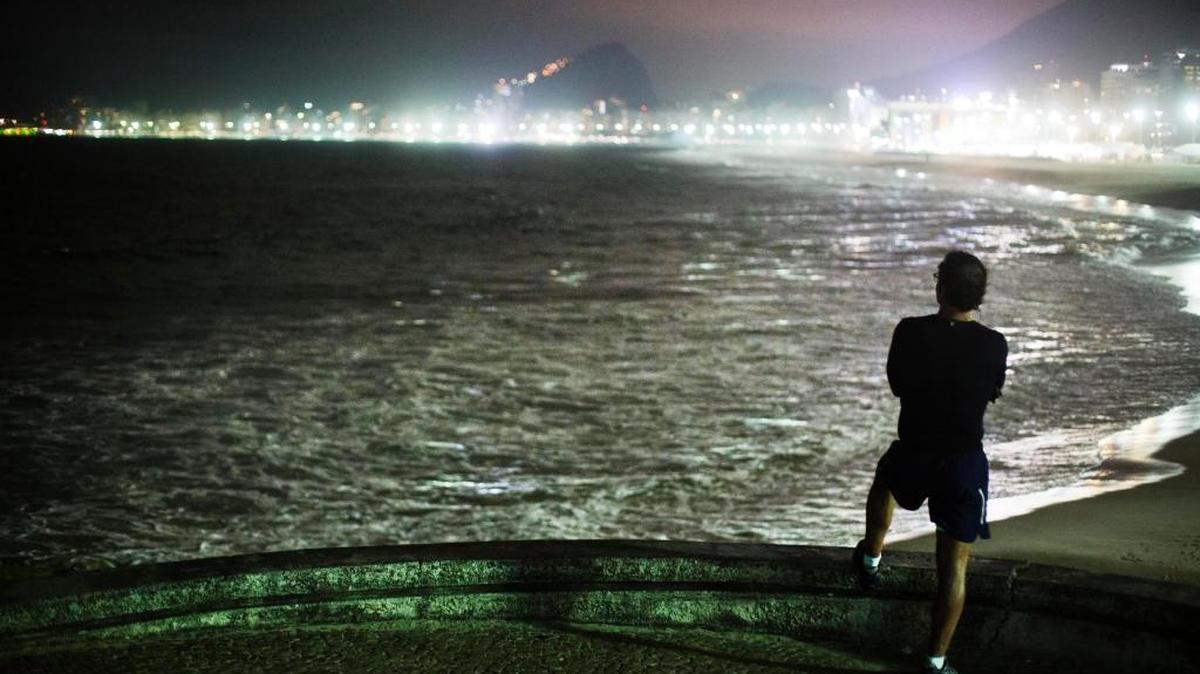 A pedestrian looks out toward Copacabana Beach ahead of the upcoming 2016 Summer Olympics in Rio de Janeiro, Brazil, Tuesday, Aug. 2.