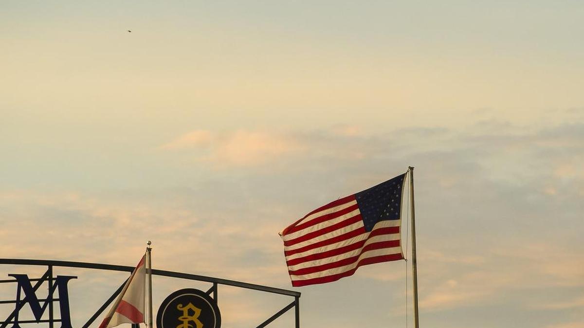 The American flag flutters in the twilight Saturday over LECOM Park as the Bradenton Marauders played the Florida Fire Frogs. Postgame fireworks drew nearly 6,000 fans to Saturday’s game. 