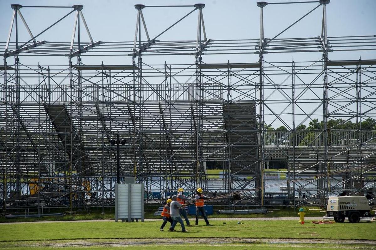 Workers put the finishing touches Friday on a tent in front of the bleachers as Nathan Benderson Park in Sarasota for the upcoming World Rowing Championships.