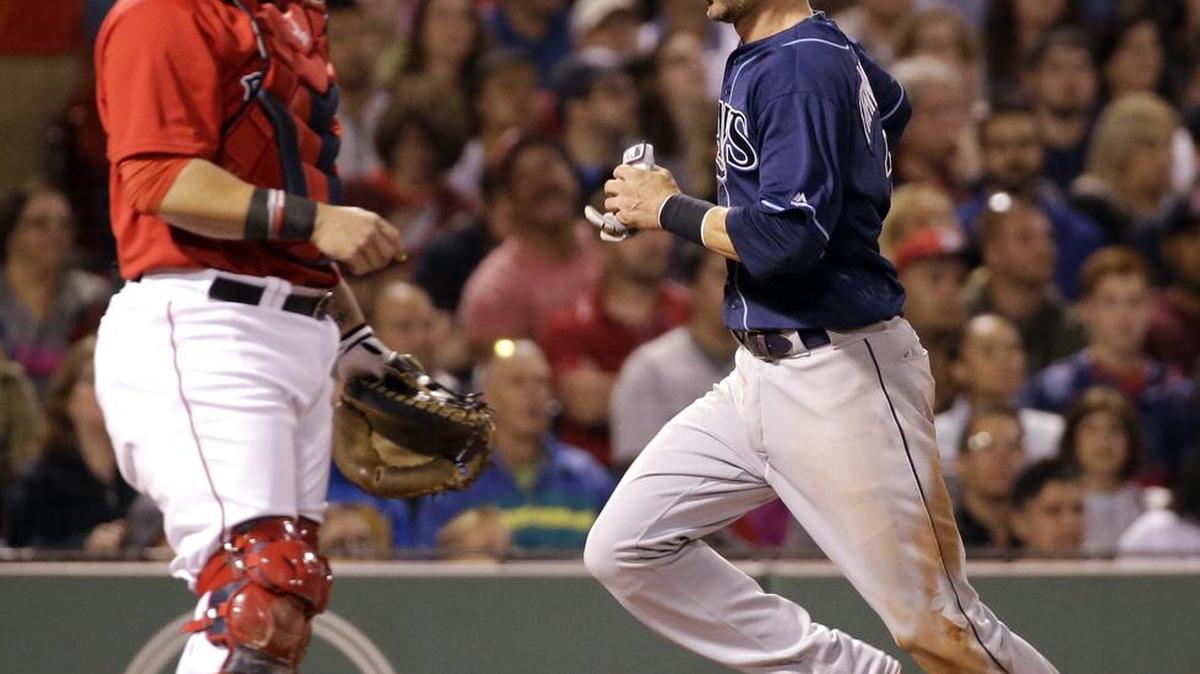 Tampa Bay’s Nick Franklin scores on a sacrifice fly by Brad Miller as Boston catcher Sandy Leon looks on in the fifth inning Friday in Boston.