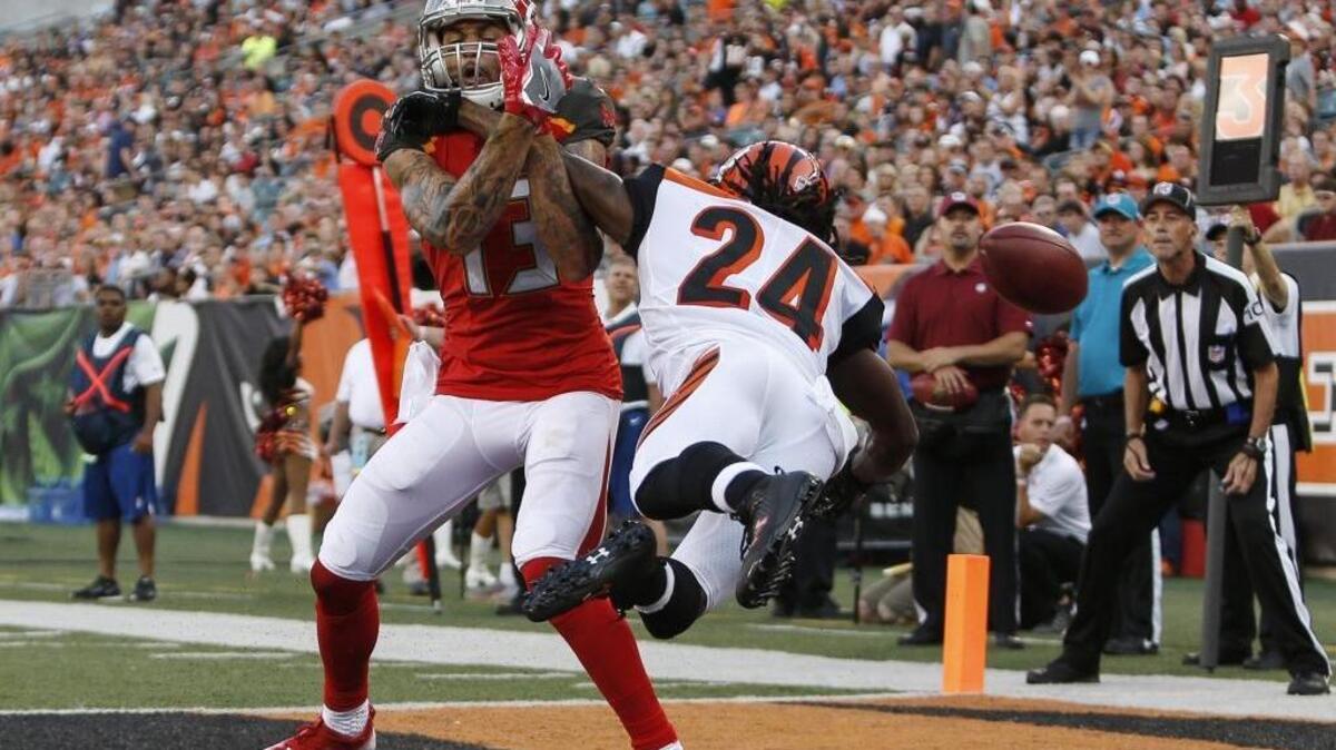 Cincinnati Bengals cornerback Adam Jones (24) breaks up a pass against Tampa Bay Buccaneers wide receiver Mike Evans (13) during the first half of a preseason NFL football game, Friday, Aug. 11, 2017, in Cincinnati. FILE PHOTO.