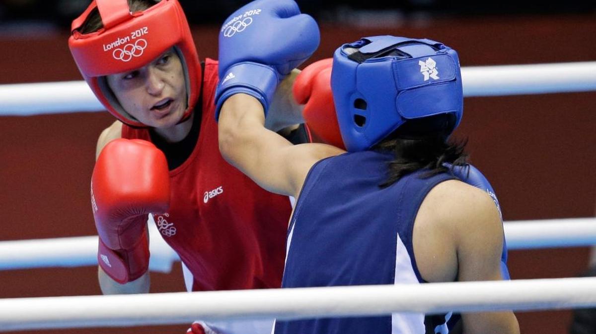 In this Aug. 8, 2012, file photo, Ireland’s Katie Taylor, left, fights Tajikistan’s Mavzuna Chorieva in a lightweight 60-kg semifinal at the 2012 Summer Olympics in London. All three gold medal winners from the inaugural women’s boxing tournament in London are back to attempt to defend their titles. Britain’s Nicola Adams, Ireland’s Katie Taylor and American middleweight Claressa Shields all stuck with their sport, which has grown rapidly in prominence and quality since women’s boxing was added to the Olympic program.