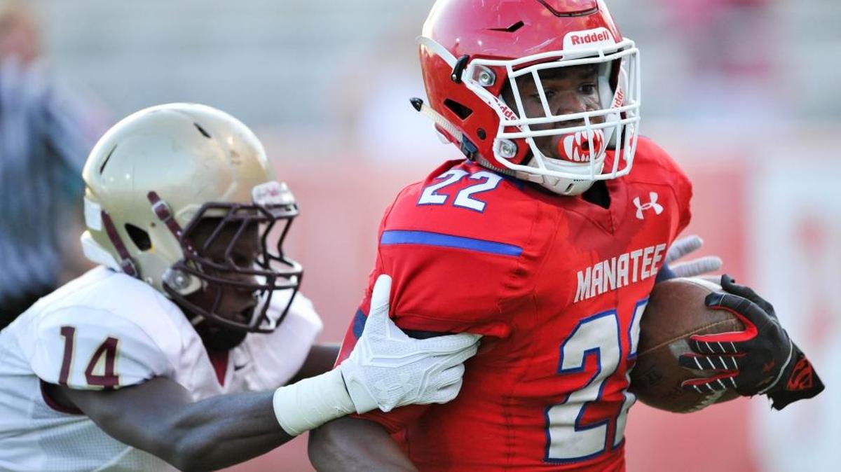 Running back Josh Booker scrambles for a touchdown in Friday night’s Manatee High spring game at Joe Kinnan Field.