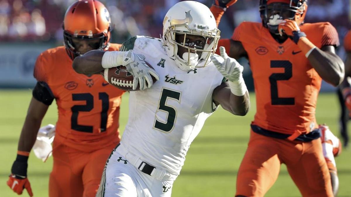 South Florida running back Marlon Mack runs past from Syracuse safety Chauncey Scissum and cornerback Wayne Morgan (2) to score during the teams’ game last season.