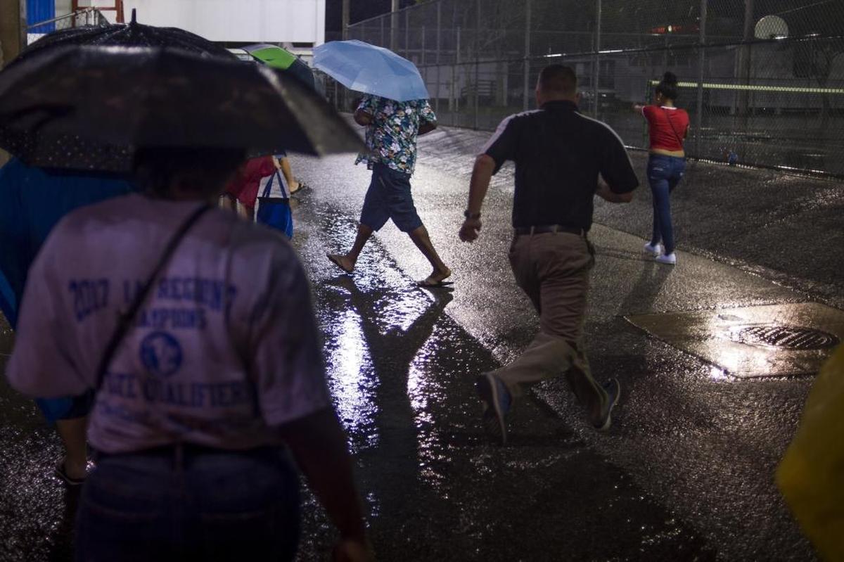 Spectators head back to their cars after last week’s Southeast-Palmetto game was postponed because of weather.