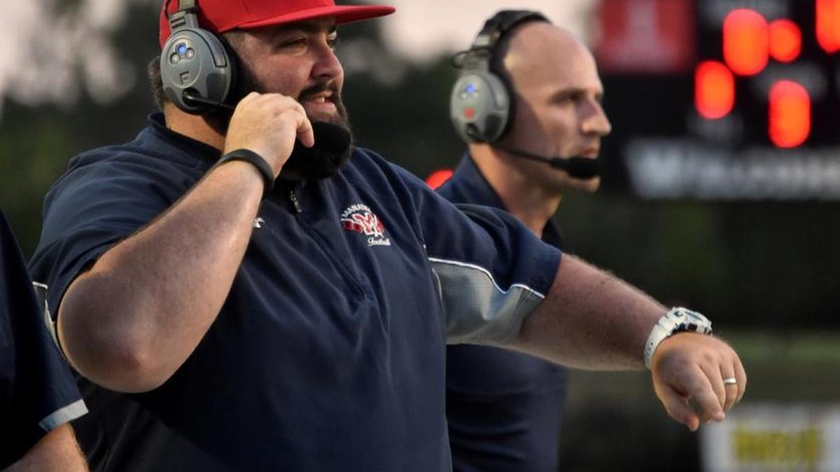 Former Manatee High School defensive coordinator Chad Choate talks with coaches in the press box during a game this season. Choate will remain on the staff in an unspecified role.