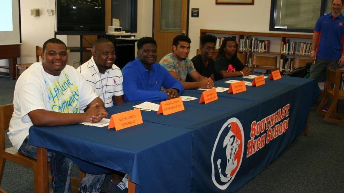 (From left) Michael Davis, Malik Galloway, Blake Green, Kevin Johnson, Quan Laguerre and Keshawn Moultrie take part in a commitment ceremony at Southeast High School.