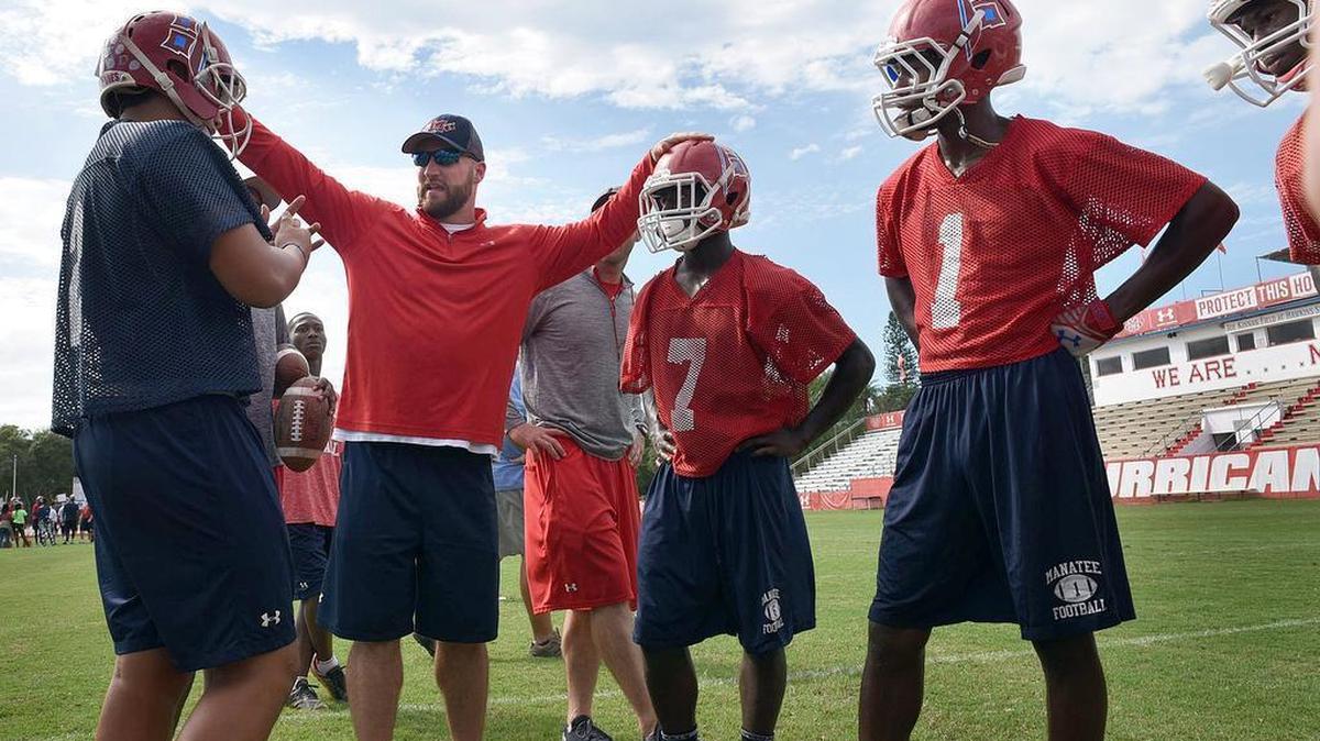 James Booth (second from left) is now the head coach at Plant City after serving as offensive coordinator at Manatee the past three seasons. Former Hurricanes quarterback Ryan Overstreet, not pictured, is transferring to join Booth with the Raiders.