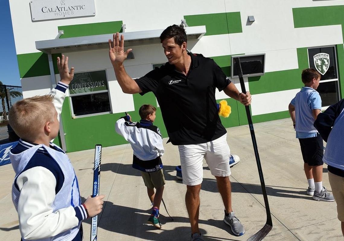 Former Tampa Bay Lightning captain Vincent Lecavalier high-fives a Robert E. Willis Elementary student attending an announcement about a new street hockey rink being built at the Premier Sports Campus in Lakewood Ranch.