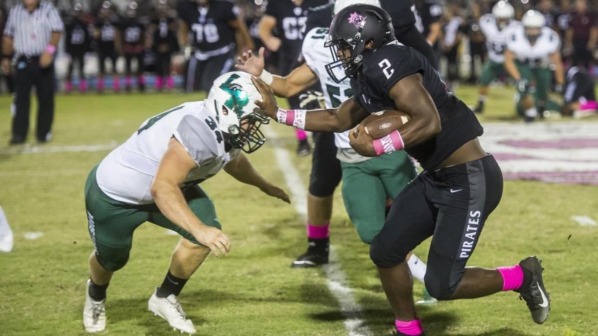 Braden River’s Deshaun Fenwick shoves down Lakewood Ranch defenders during Friday night’s 55-7 Pirates win.
