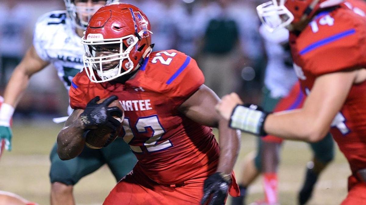 Manatee's Josh Booker drives through Venice's defense at Manatee's Kinnan Field at Hawkins Stadium Friday night.