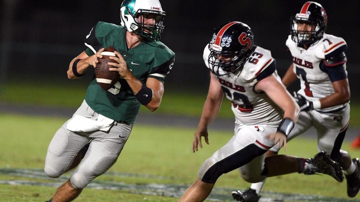 Lakewood Ranch's Justin Curtis looks for a receiver while playing a rain-delayed game against Spring Hill Springstead Friday night.