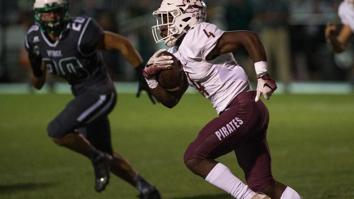 Braden River's Raymond Thomas runs past Venice defenders towards the end zone during Braden River High School's game at Venice High School on Friday night, October 14, 2016 in Venice.