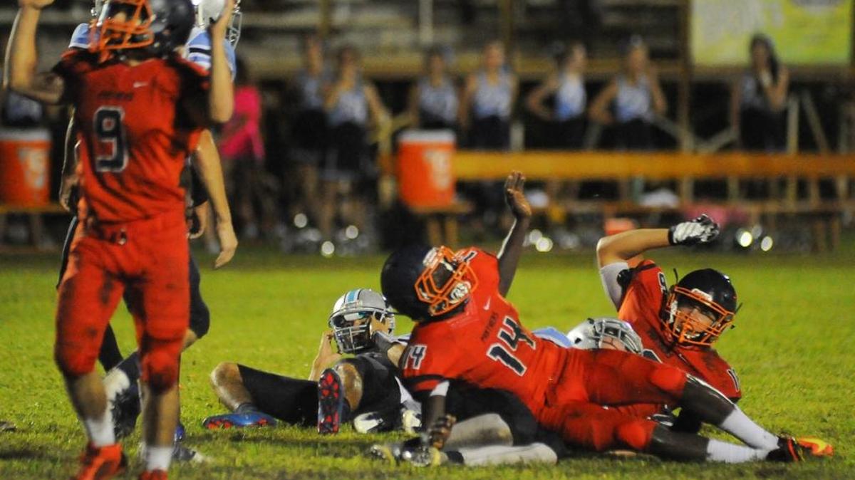 Place kicker Bathie Tham (14) lies on the ground after getting hit on a field goal attempt, drawing an running into the kicker penalty. The Out Of Door Academy Thunder were defeated by the Bradenton Christian Panthers 40-22 in football action at Bradenton Christian School on Friday evening, September 30, 2016. DAVID W DOONAN | Special To The Herald
