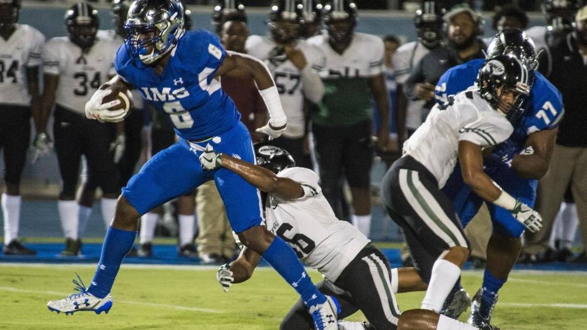 IMG's Trey Sanders powers through Miami Central defense as IMG Academy takes on Miami Central on Friday evening at IMG Academy in Bradenton.